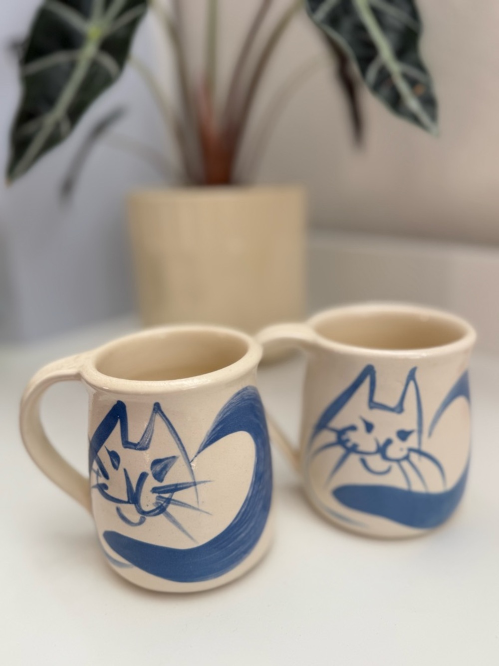 Handmade Cream Ceramic Cat Mugs with Blue Artwork, set of 2